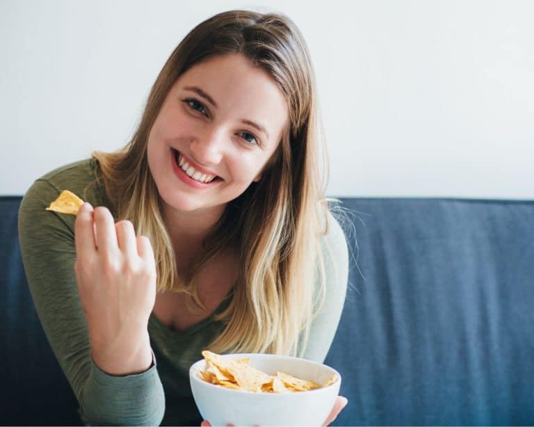 woman eating chips from a bowl